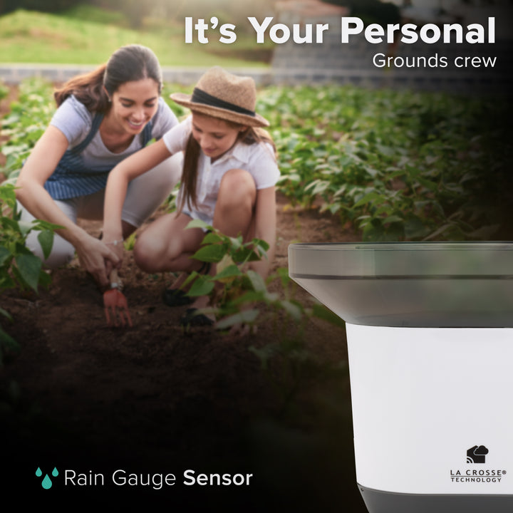 Alert and monitoring gray and white rain gauge sensor for wi-fi weather stations and gateways in the foreground with a mother and child gardening in the background