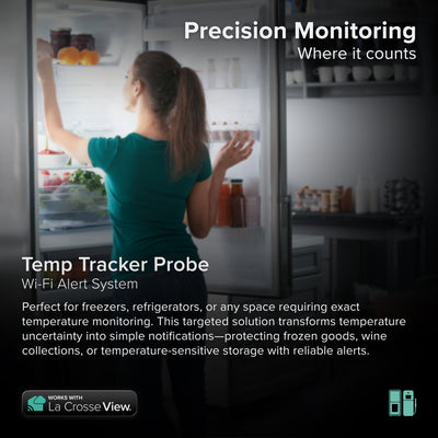 Temp Tracker alert and monitoring system offers the ability to monitor those hard to reach places with a cabled temperature probe sensor that includes an lcd screen for ambinet temerature and humidity on the sensor casing shown in a kitchen with a female opeing a refrigerator with helathy food on the shelves in a semi dark contemporary kitchen in greys and whites, the system works with the Bridge gateway and the La Crosse View app