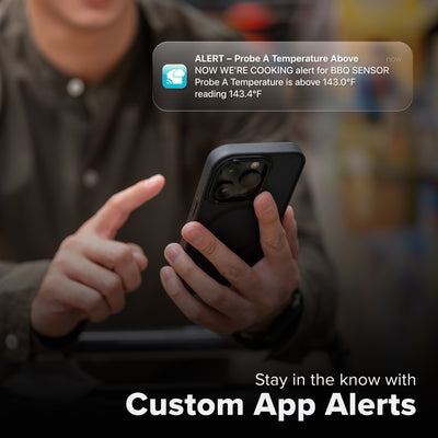 La Crosse Technology Alert and Monitoring system with a male  receiving a message on their smartphone of an alert that their meat thermometer barbeque sensor temperature has  gone above the parameters of a custom alert for the bbq sensor with text that says stay in the know with Custom Alerts