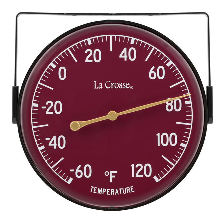 Head-on image of the 104-1512D 5-inch Dial Thermometer with Bracket features a wine red dial with white temperature readings in a Fahrenheit scale from -60 to 120 degrees, with an antique gold pointer shown with the mounting bracket/stand positioned at the top