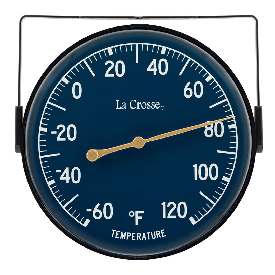 Head-on image of the 104-1512E 5-inch Dial Thermometer with Bracket features a navy blue dial with white temperature readings in a Fahrenheit scale from -60 to 120 degrees, with an antique gold pointer shown with the mounting bracket/stand positioned at the top
