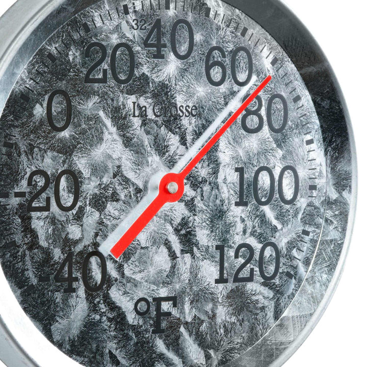 Close-up image of the dial and frame of the 104-2822 8-inch Galvanized Dial Thermometer, galvanized metal dial with black number markings and a red pointer with a temperature scale from -40 to 120 degrees Fahrenheit