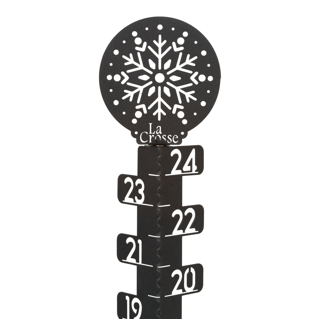 Detail view of the ornamental snowflake accent at the top of the 139-4686 metal snow gauge showing the La Corsse logo and inch measurement markings laser cut in the metal