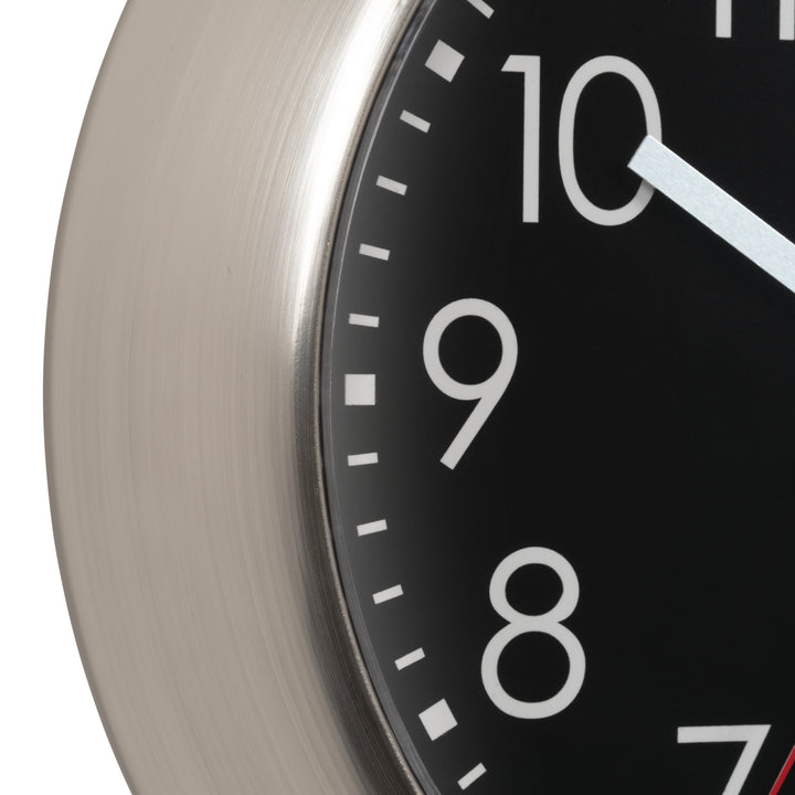 Close-up of a clock face with white numbers on a black background