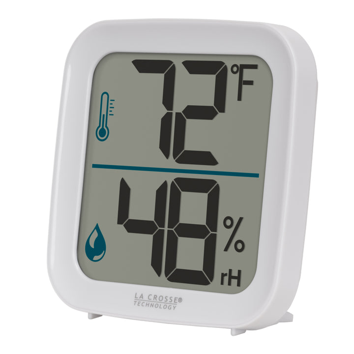 Left-facing image of the 302-1407W Thermometer with Temperature and Humidity - White. The thermometer features a white square case and a digital screen with large temperature and humidity readings. Next to the digits are corresponding temperature and humidity icons in blue.