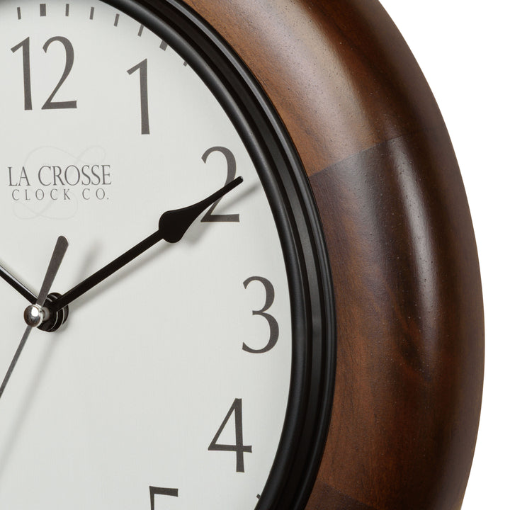 Closeup of the dark wood stained frame and white dial of the 404-2625 Linwood 10-inch wall clock
