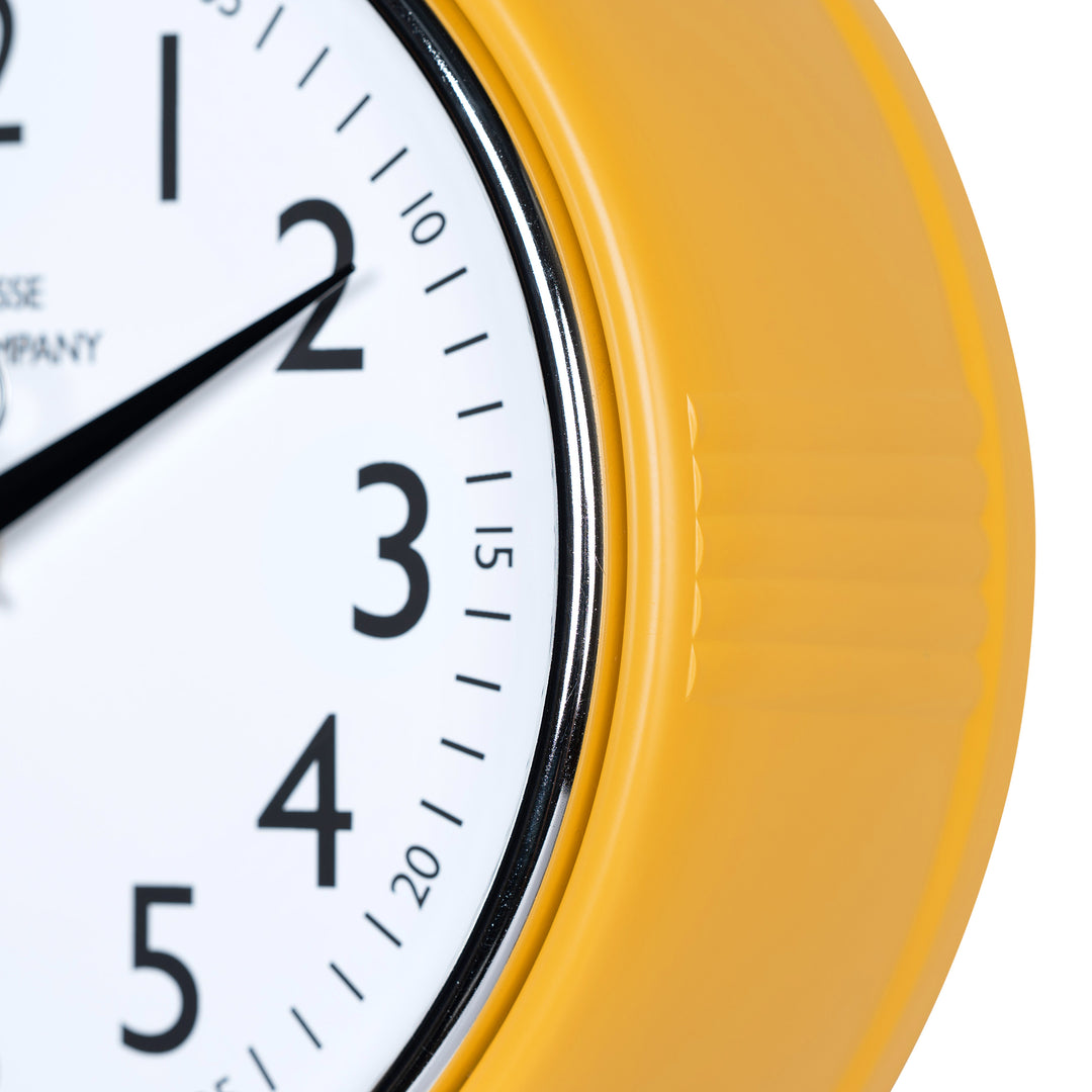 Close-up frame image of the 404-3024MY 9.5-inch Diner Clock – Mustard Yellow, features a retro-style mustard yellow frame with a white dial, chrome bezel, black numbers and minute markings, black metal hour and minute hands, and a silver second hand.