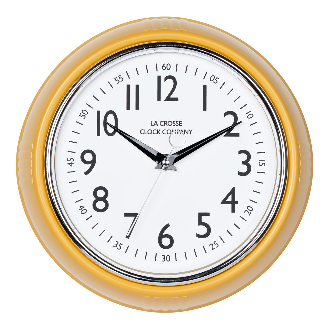 Head-on image of the 404-3024MY 9.5-inch Diner Clock – Mustard Yellow. The clock features a retro-style mustard yellow frame with a white dial, chrome bezel, black numbers and minute markings, black metal hands, and a silver second hand.