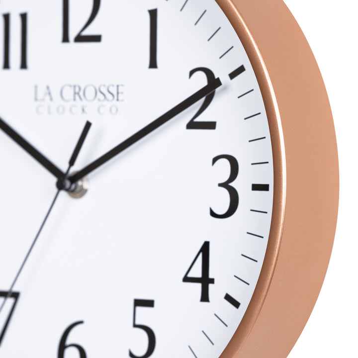 Close-up image of the Copper frame of the 404-3025NB 10-inch Basic Decor Wall Clock with a white dial, black numbers, hour, minute, and second hands