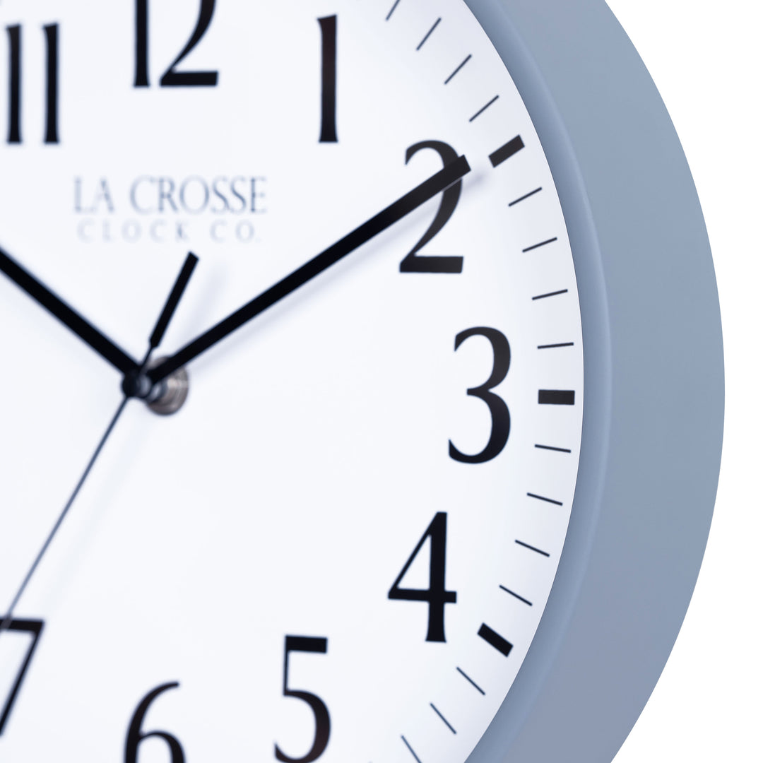 Close-up image of the Gray Blue frame of the 404-3025GB 10-inch Basic  Wall Clock - Gray Blue featuring a white dial, with black numbers, hour, minute, and second hands