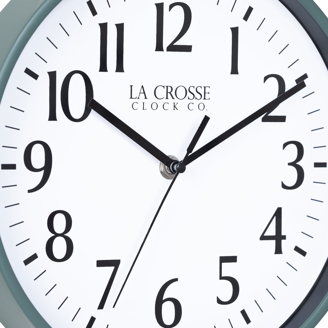 Close-up image of the dial of the 404-3025G 10-inch Basic Decor Wall Clock with a Green frame, white dial with black numbers, hour, and minute hands, and a black second hand