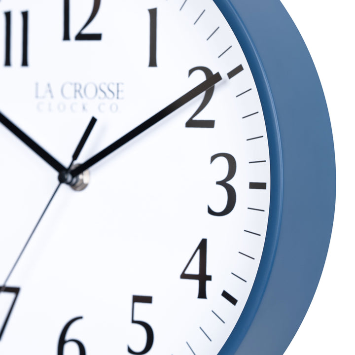 Close-up image of the Navy Blue frame of the 404-3025NB 10-inch Basic Decor Wall Clock with a white dial,  black numbers, hour, minute, and second hands