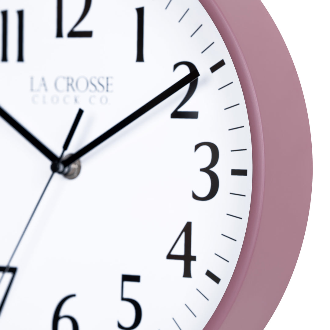 Close-up image of the Ruby Red Rose frame of the 404-3025RR 10-inch Basic Decor Wall Clock with a white dial,  black numbers, hour, minute, and second hands