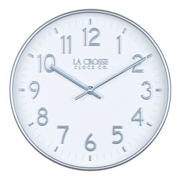 Head on view of view of the 404-3027B Tovi modern wall clock showing a white dial with silver Arabic numbers and a flush mount silver case  and matching silver hour and minute hands