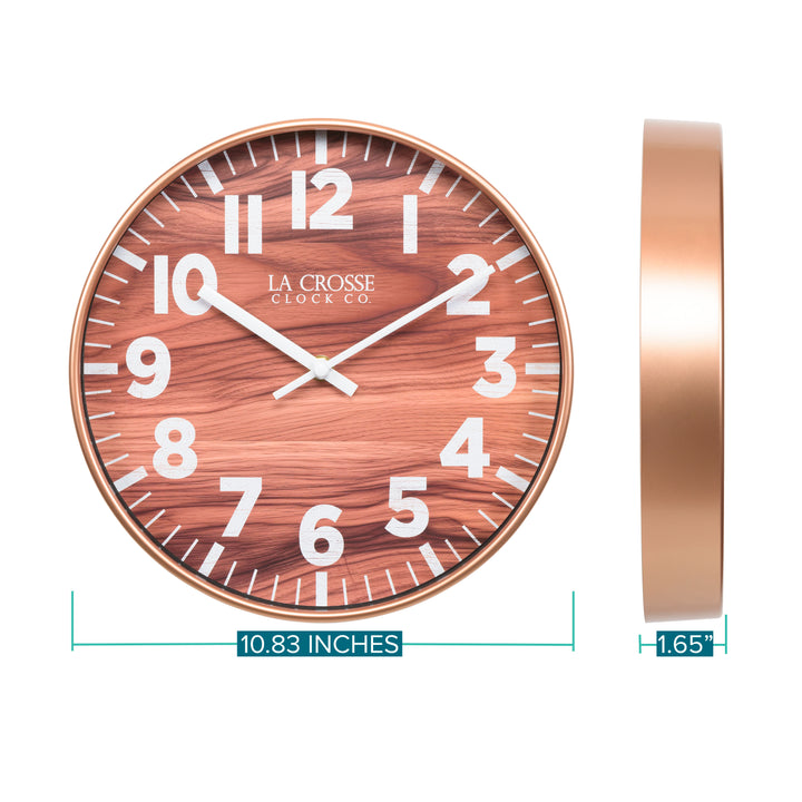 Orthographic image of the 10.8-inch Atwood Wall Clock featuring a copper finish frame, a wood design dial, white numbers, and white metal hour and minute hands. The dimensions are displayed as 10.83-inches in diameter with a depth of 1.65-inches.