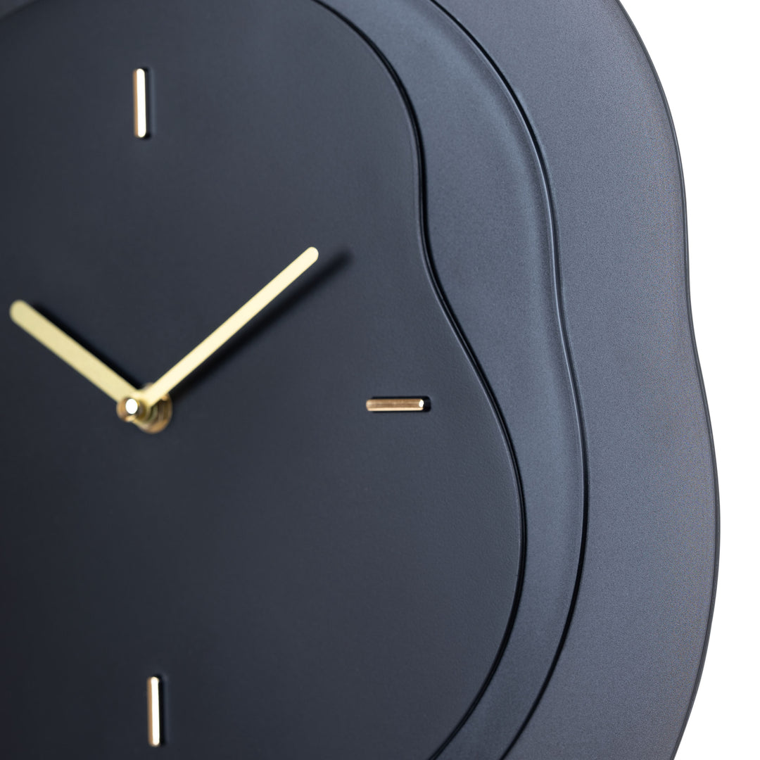 Close-up frame image of the 404-3039B 15.2-inch Drift Wall Clock – Black featuring the open face multi-layered design with drifting contours, metal hands, and raised number markings in a brass finish.