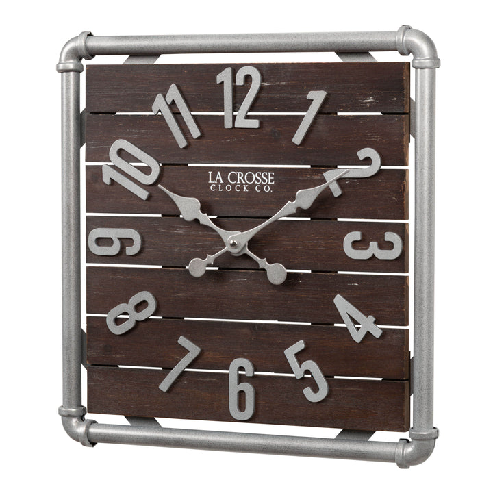 Left-facing image of the 404-3412L 16-inch Foundry Metal &amp; Wood Wall Clock - Light. The clock features a square metal pipe frame in a weathered pewter finish, a truffle-brown-stained wood slat clock face with pewter-finished metal numbers and hands.