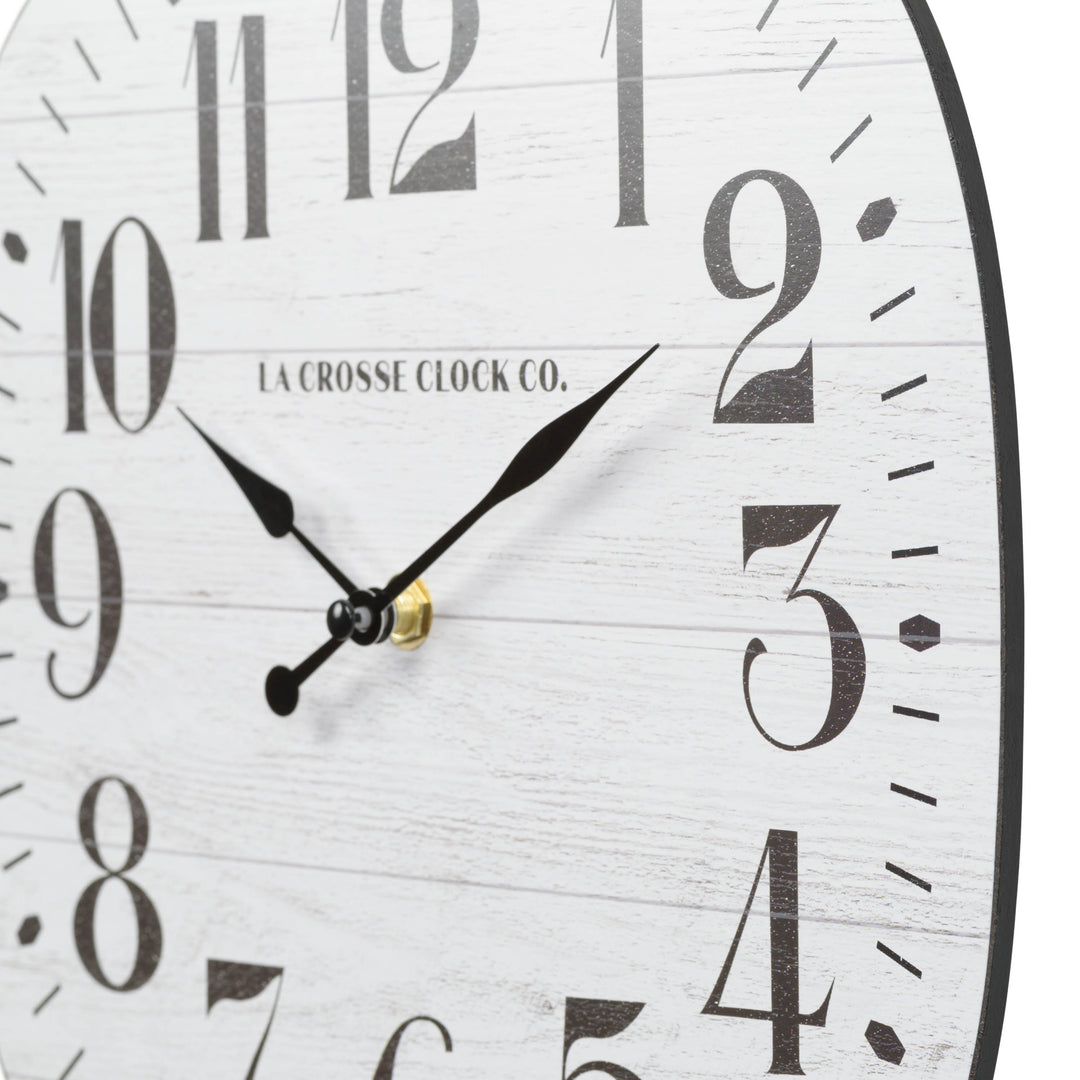 Dial close up of the 404-3428 11-inch Sylvie square MDF open face wall clock featuring a faux whitewash wood dial black numbers and metal hands