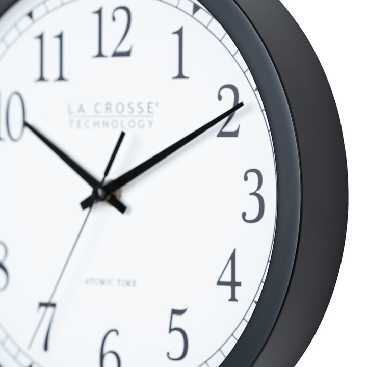 Close-up frame image of the 404-3826 10-inch Atomic Analog Wall Clock showing the flush-mount detail of the frame. The clock features a black flush-mount frame, stylized black numerals, and black metal hands.