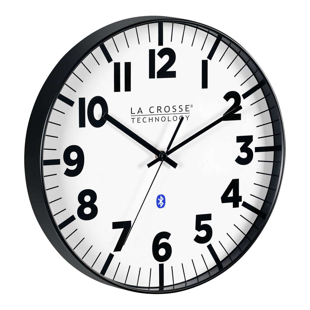 Right-facing image of the 404-4536 14.2-inch Insta-Set Wall Clock with Bluetooth® Technology the clock features a white dial with bold black numbers and markings, a black flush-mount frame, and black hands.