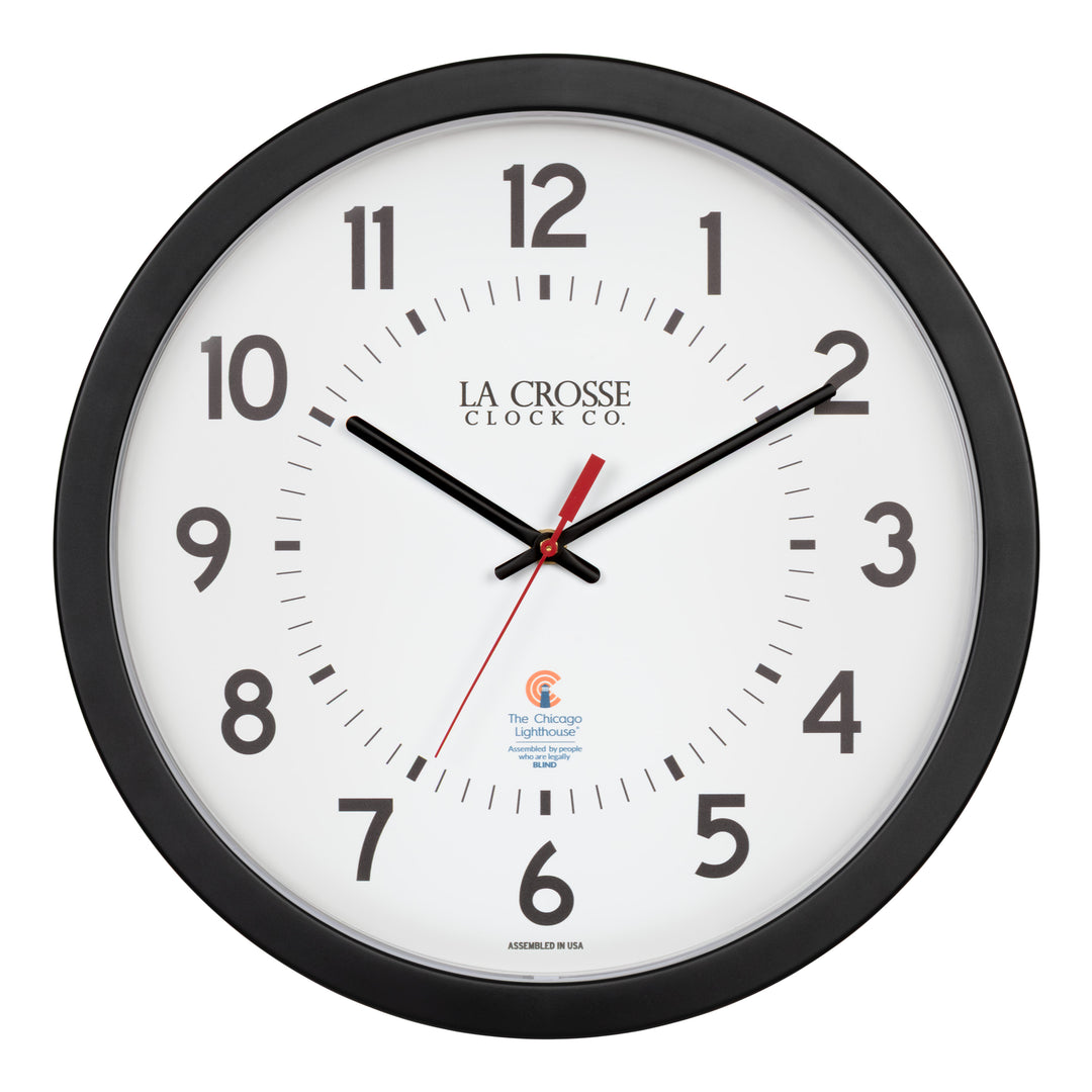 Head-on image of the 404-5537 14.5-inch Wall Clock with black bold numbers, black hour and minute hands, and a red second hand. Two logos apear on the clock, 
La Crosse Clock Co. and Chicago Lighthouse industries - a partner that employs the blind to bring this classic wall clock to consumers.
