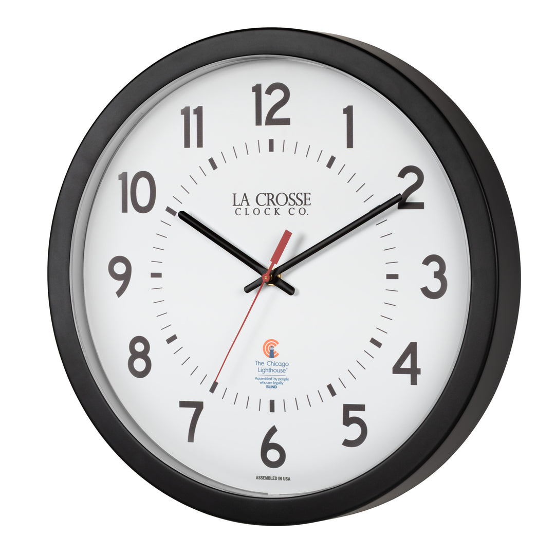 Left-facing image of the 404-5537 14.5-inch Wall Clock with black bold numbers, black hour and minute hands, and a red second hand. Two logos apear on the clock, 
La Crosse Clock Co. and Chicago Lighthouse industries - a partner that employs the blind to bring this classic wall clock to consumers.