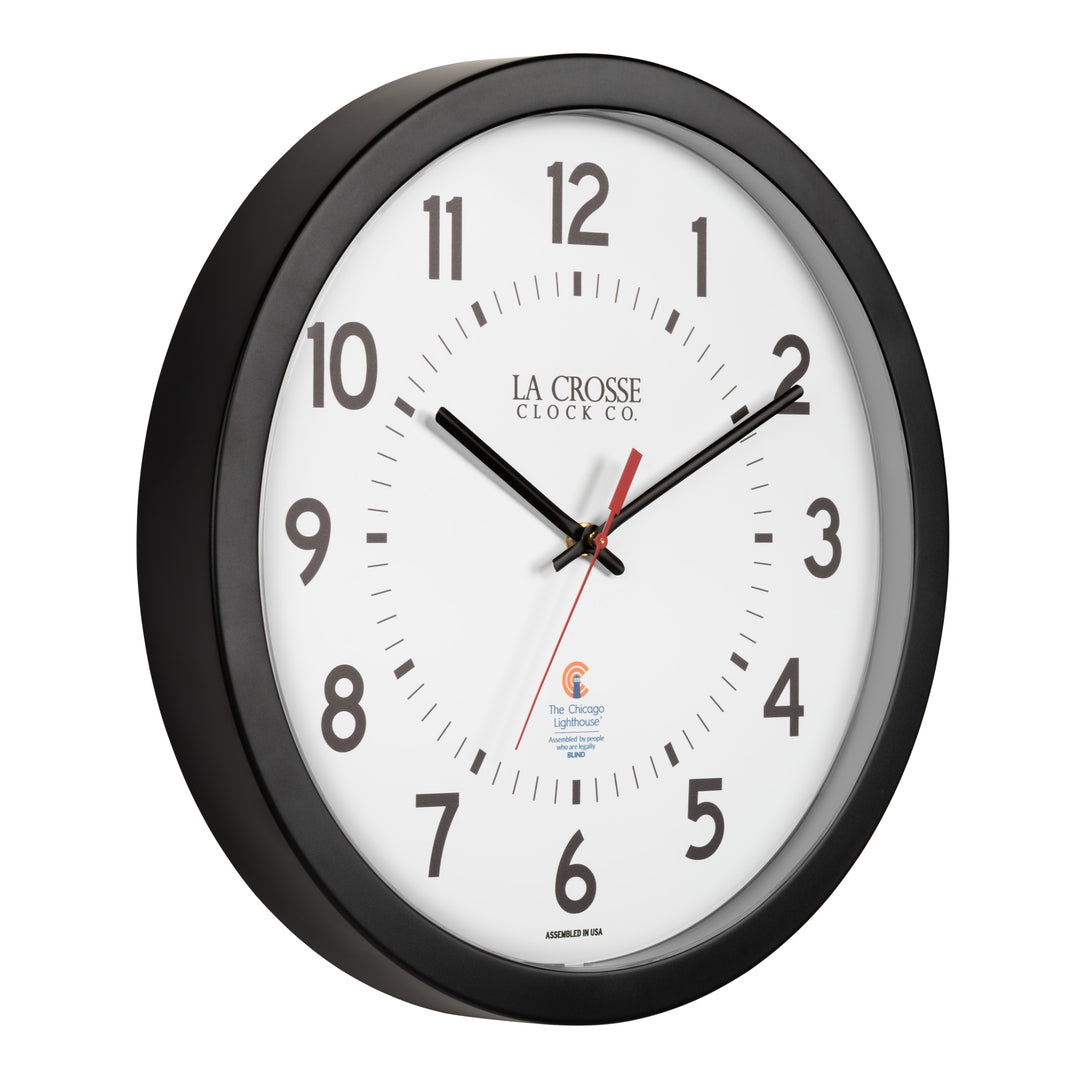 Right-facing image of the 404-5537 14.5-inch Wall Clock with black bold numbers, black hour and minute hands, and a red second hand. Two logos apear on the clock, 
La Crosse Clock Co. and Chicago Lighthouse industries - a partner that employs the blind to bring this classic wall clock to consumers.