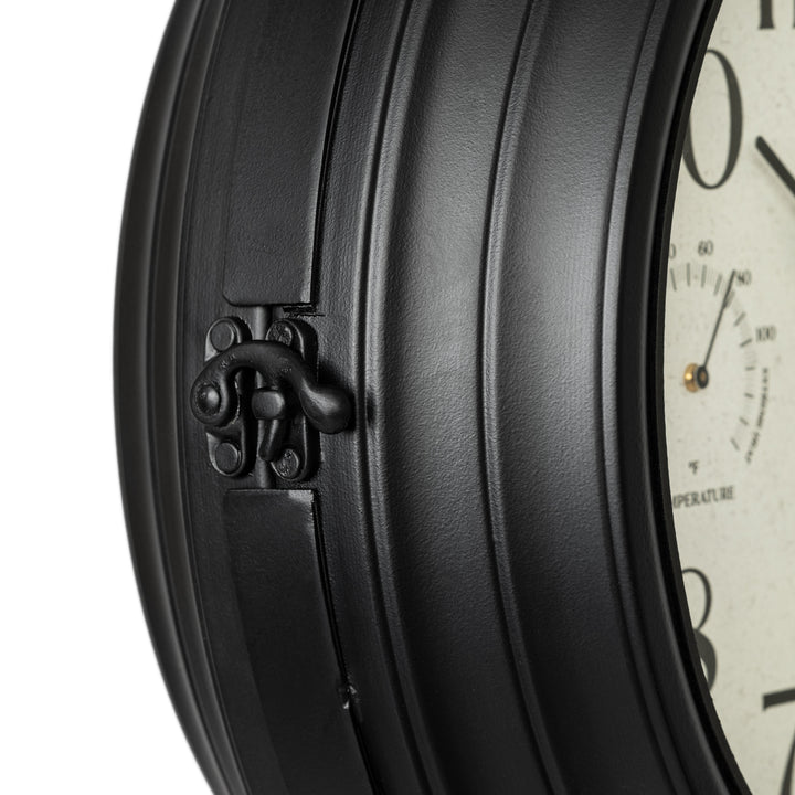 Close-up detail image of the clasp for the 425-34188 Outdoor Dual-Sided Metal Pedestal Clock. The clock features a temperature dial in a Fahrenheit scale, a humidity dial, decorative black metal hands, black numbers on a flecked white dial surrounded by a dark brown metal frame on a 72-inch pedestal.
