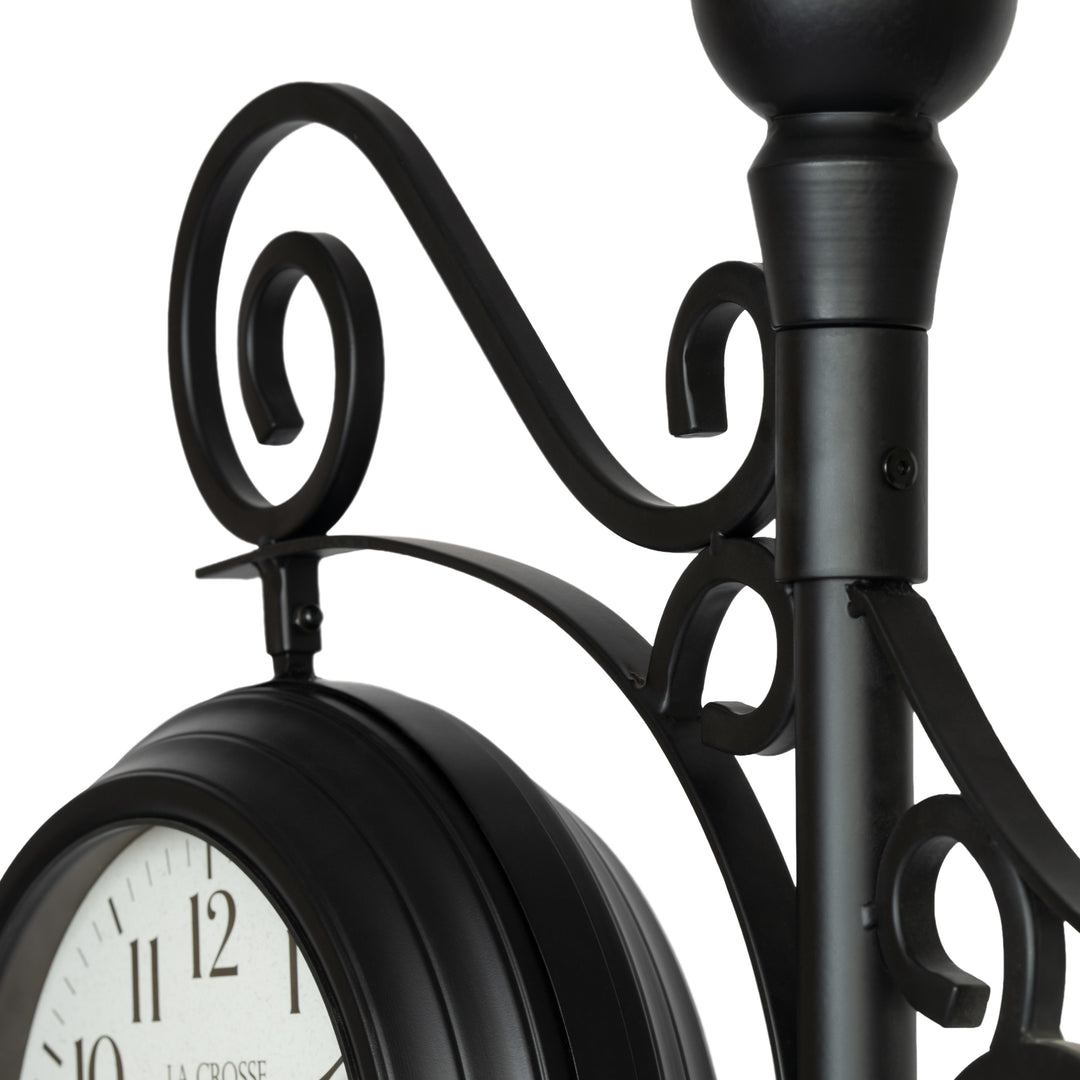 Close-up detail image of the 425-34188 Outdoor Dual-Sided Metal Pedestal Clock showing the scroll work and how the clocks are attached.