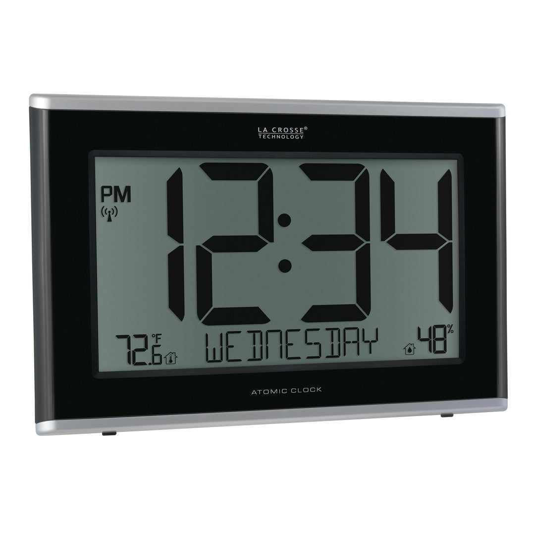 Right-facing image of the 513-36908 Executive Atomic Digital Wall Clock with Temperature and Humidity features a black frame, a large LCD screen displaying 12:34 pm, Wednesday, indoor temperature, humidity, and signal icons.