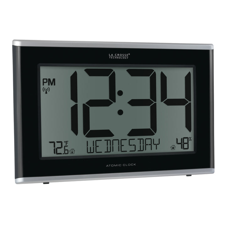 Right-facing image of the 513-36908 Executive Atomic Digital Wall Clock with Temperature and Humidity features a black frame, a large LCD screen displaying 12:34 pm, Wednesday, indoor temperature, humidity, and signal icons.