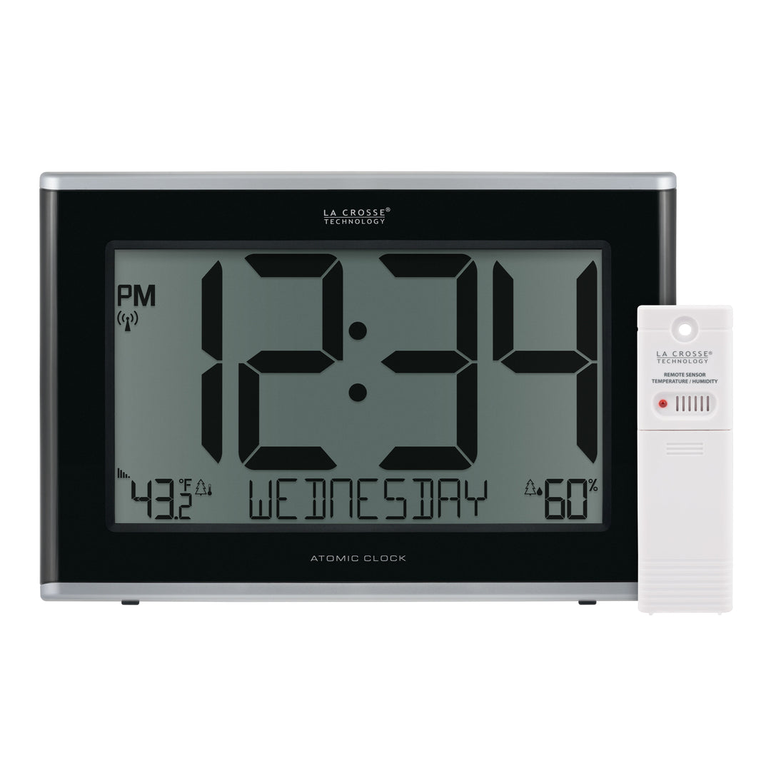 Group image of the 513-36908 Executive Atomic Digital Wall Clock with Temperature and Humidity features a black frame, a large LCD screen displaying 12:34 pm, Wednesday, indoor temperature, humidity, and signal icons, shown with the included white remote temperature and humidity sensor.