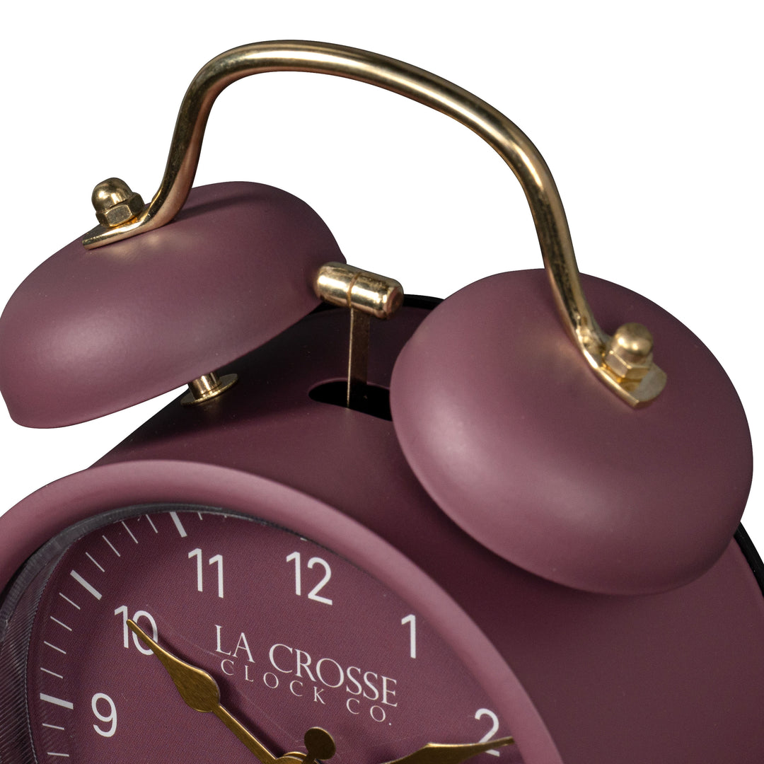 Close-up detail image of the 617-3314RR Metal Twin Bell Alarm Clock – Ruby Red, showing the twin bell and hammer of the alarm clock. The clock features a ruby red dial with white numbers, gold hands and accents, in a ruby red metal case.