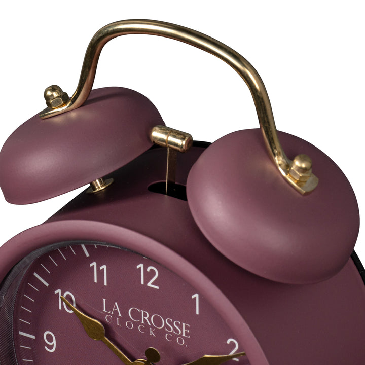 Close-up detail image of the 617-3314RR Metal Twin Bell Alarm Clock – Ruby Red, showing the twin bell and hammer of the alarm clock. The clock features a ruby red dial with white numbers, gold hands and accents, in a ruby red metal case.