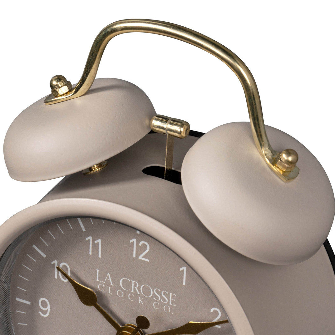 Close-up detail image of the 617-3314TP Metal Twin Bell Alarm Clock – Taupe, showing the twin bell and hammer of the alarm clock. The clock features a Taupe dial with white numbers, gold hands and accents, in a taupe metal case.