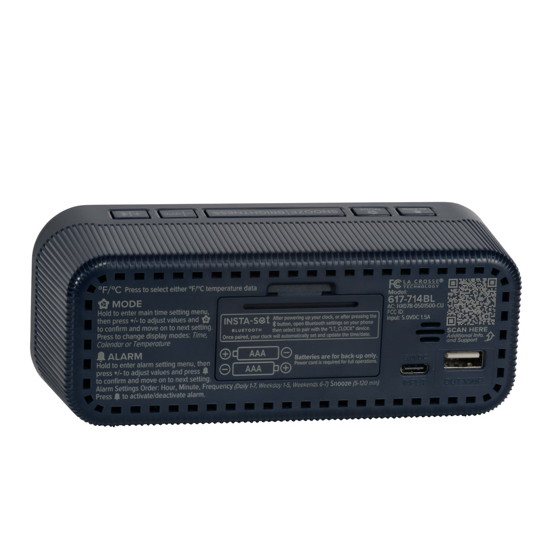 Angled back view of the 617-714BL Insta-Set Digital LED Alarm Clock with Bluetooth® Technology - Navy, showing the buttons, the battery compartment, the USB-C power port, the USB-A charging port, and the operating instructions.