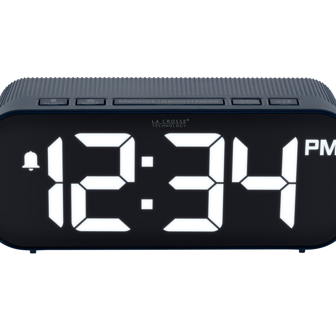 Close-up image of the buttons of the 617-714BL Insta-Set Digital LED Alarm Clock with Bluetooth® Technology - Navy. The alarm clock features large white digits, a PM indicator, and an alarm icon in a navy blue case.