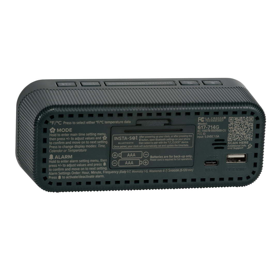 Angled back view of the 617-714G Insta-Set Digital LED Alarm Clock with Bluetooth® Technology - Green, showing the buttons, the battery compartment, the USB-C power port, the USB-A charging port, and the operating instructions.