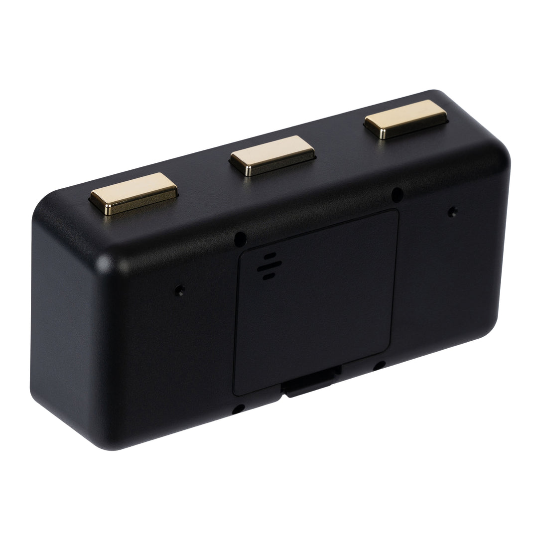 Angled back image of the 636-379B Daily Flip Tabletop Clock with Calendar – Black, showing the battery compartment with the cover in place, and the three brass buttons to operate the calendar and the alarm.