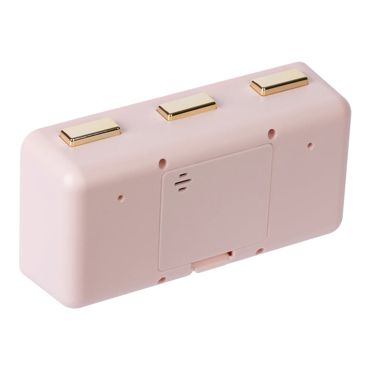 Angled back image of the 636-379P Daily Flip Tabletop Clock with Calendar – Pink Blush, showing the battery compartment with the cover in place, and the three brass buttons to operate the calendar and the alarm.