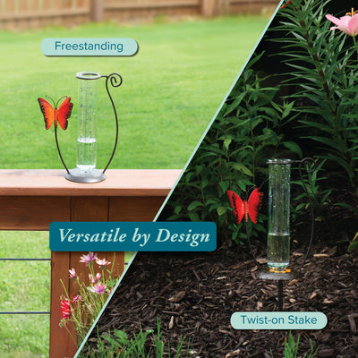 704-13077 Glass rain gauge with butterfly design on a stand and stake against a garden background.