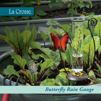 704-13077 Butterfly rain gauge with La Crosse branding in a garden setting