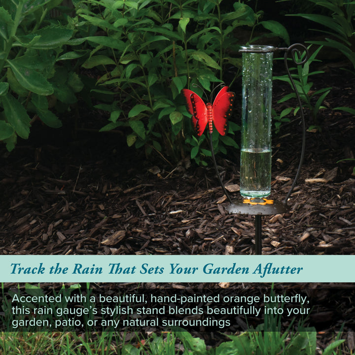 704-13077 Rain gauge with a hand-painted orange butterfly in a garden setting