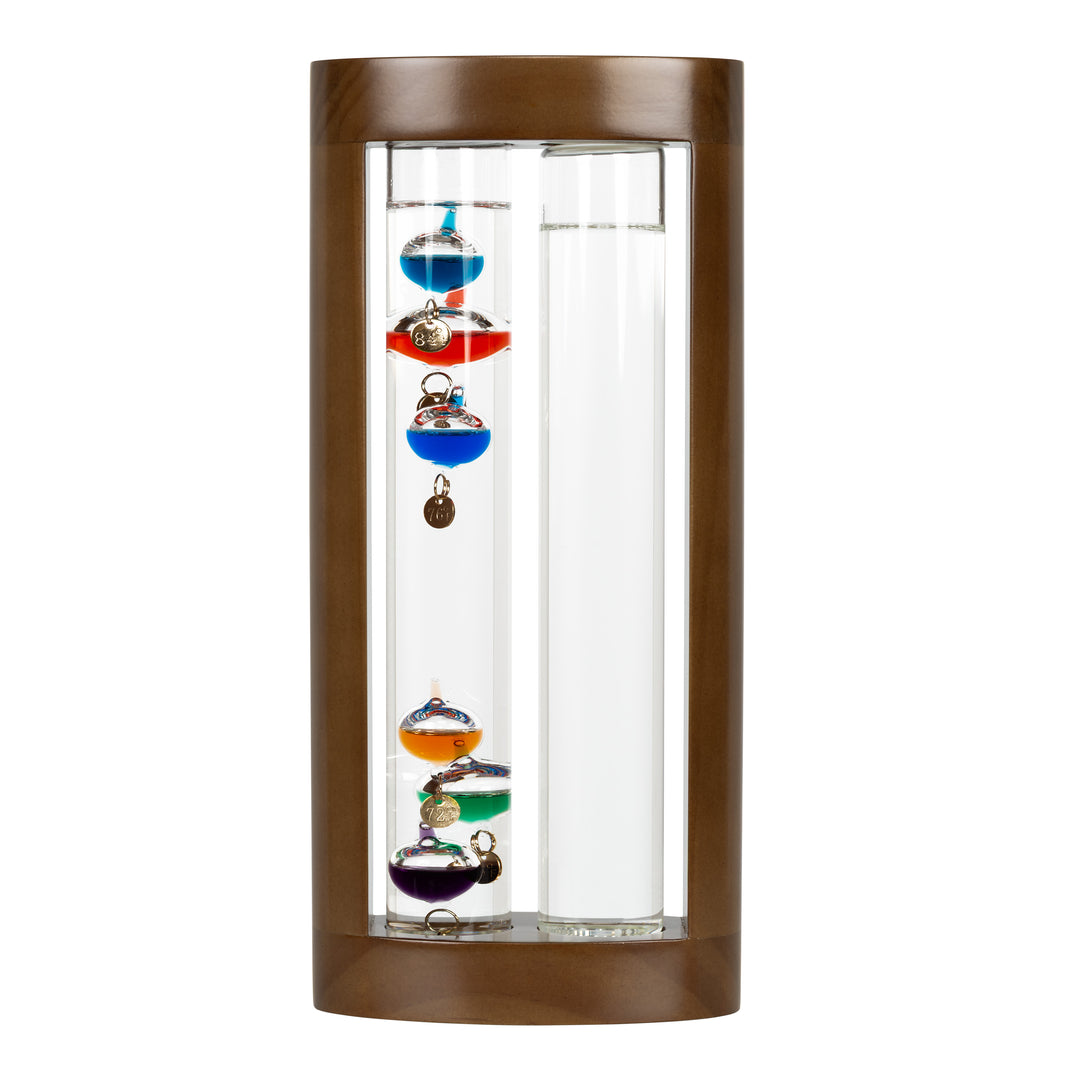 Headon image of the 914-4928SG 11-inch Galileo Thermometer + FitzRoy Storm Glass. The thermometer features a solid walnut-finished wooden casing with two glass tubes: one with floating temperature spheres in various colors, and the second containing a changing liquid that indicates the forecast.