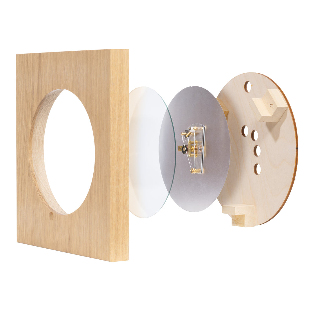 Cross section image of the 914-620 Sauna Thermometer and Hygrometer - Wood showing the construction of the cut out wood frame, the domed glass lens, the hand tied mechanism, and the backing.