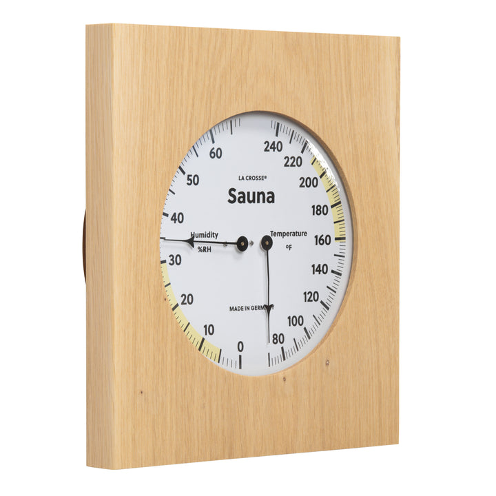Right facing image of the 914-620 Sauna Thermometer and Hygrometer dial in oiled oak wood casing displaying a dial split in half with temperature on the right in Fahrenheit from 60 degrees to 245 degrees with optimal range in yellow and the left half showing humidity readings from 0 percent to 75 percent with the optimal range highlighted in yellow