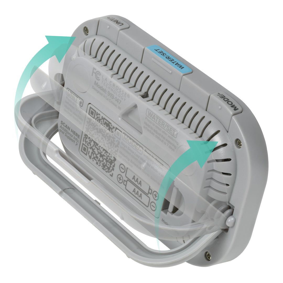Back-angled image of the  919-147 Digital plant care timer with temperature and humidity. Battery-operated, the timer features a white and gray case with a kickstand, hanging hole, and battery compartment. The three buttons are shown across the top with instructions on the back of the timer. There are teal arrows to show how the pull-down kickstand operates.