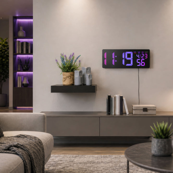 S69548 R.G.Bright LED Wall Clock with Outdoor Temperature and Underglow displayed in a modern living room with sleek black design, oversized purple LED digits, and ambient underglow lighting. Wall-mounted clock shows time, calendar, and temperature display while complementing contemporary home décor and gaming-inspired lighting accents.
