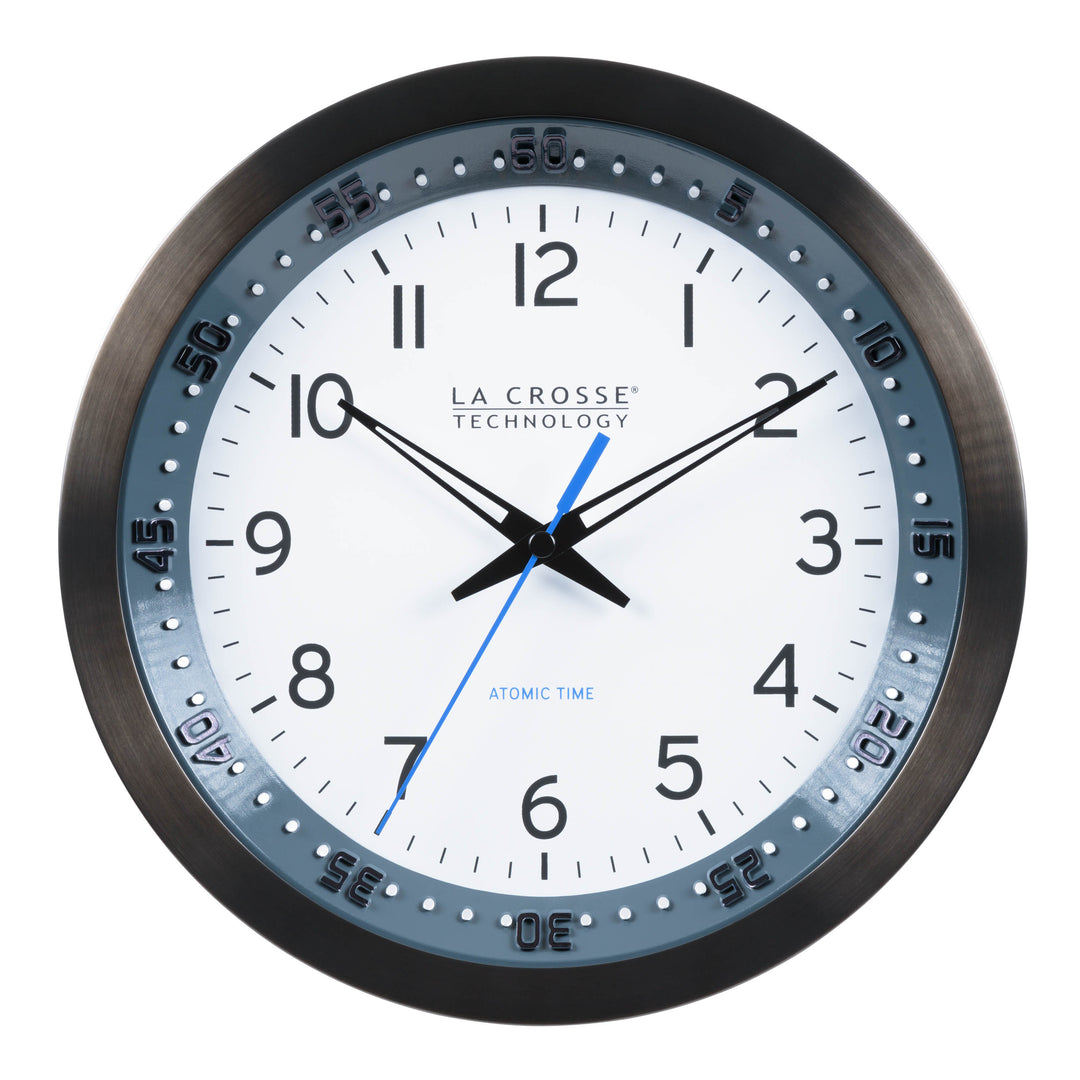 Head-on image of the 404-54667 10-inch Atomic Metal Wall Clock with Blue Chapter Ring. The clock features a black stainless steel frame with a blue chapter ring and raised seconds indicators, surrounding a white dial with black numbers, metal hands, and a blue accent second hand.